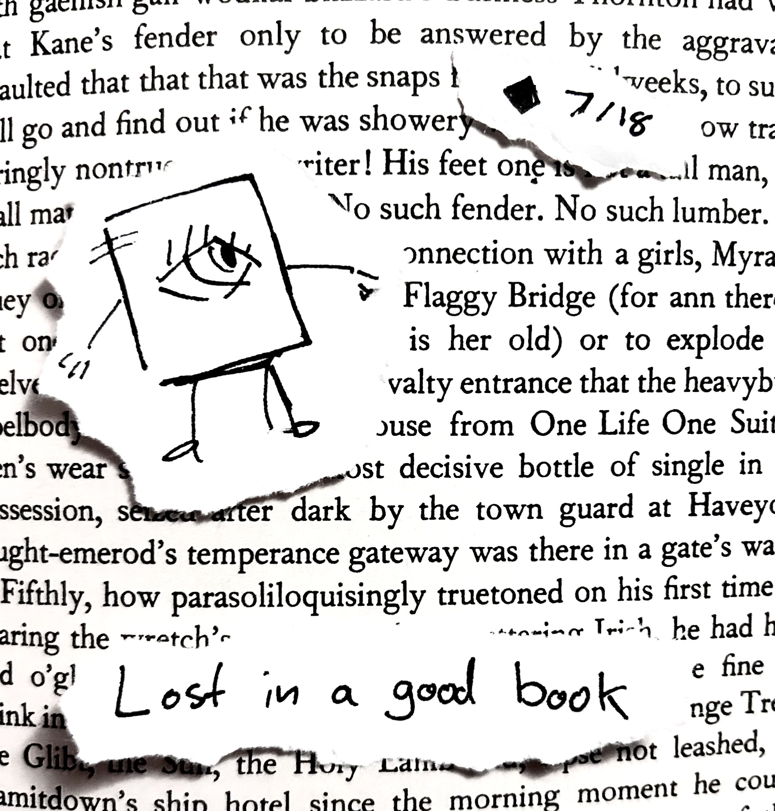 The little guy glances around over a page of Finnegans Wake. The caption reads "lost in a good book"